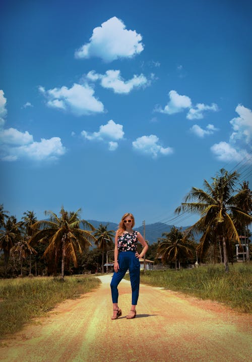 Photo of Woman Standing On Dirt Road