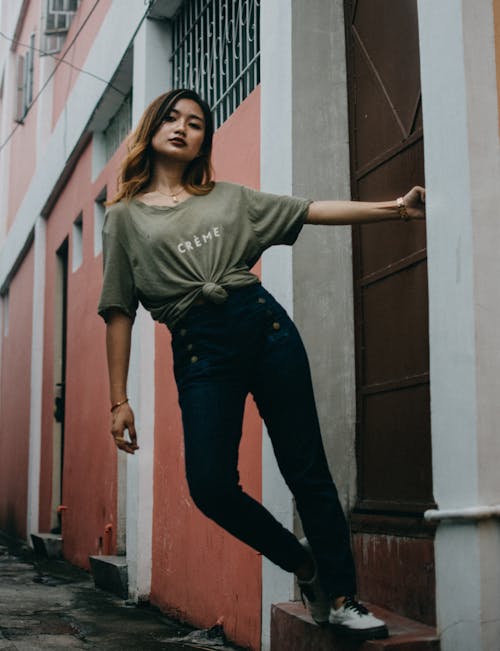 Confident ethnic young woman standing on step