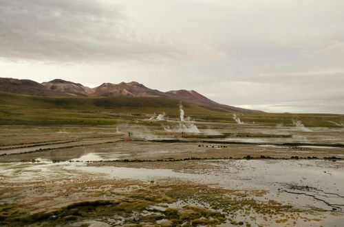 Free Stunning geothermal fields near San Pedro de Atacama showcasing steam rising in a barren landscape. Stock Photo