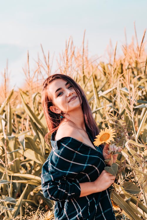 Photo of Woman Holding Sunflower