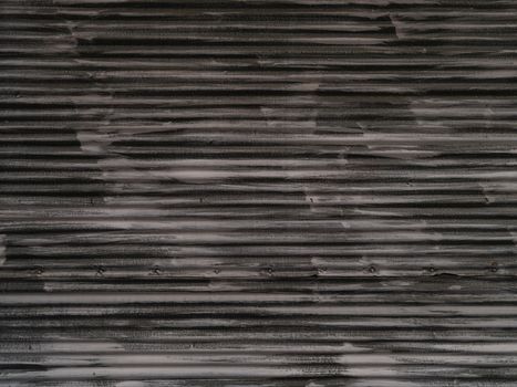 Close-up of a textured metal surface with horizontal stripes and a layered pattern.