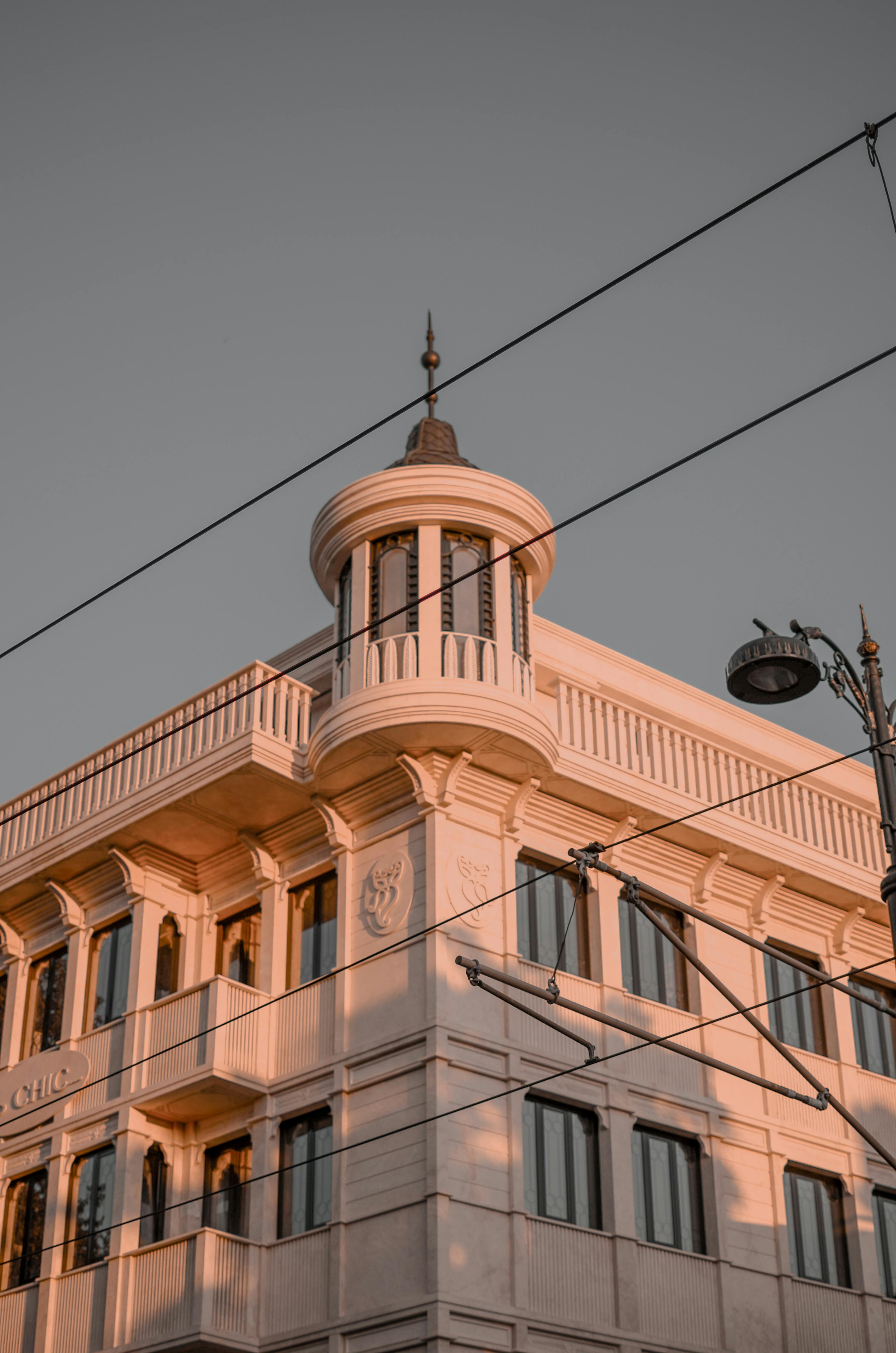 Free A captivating low angle view of a classic architectural design bathed in sunset hues. Stock Photo
