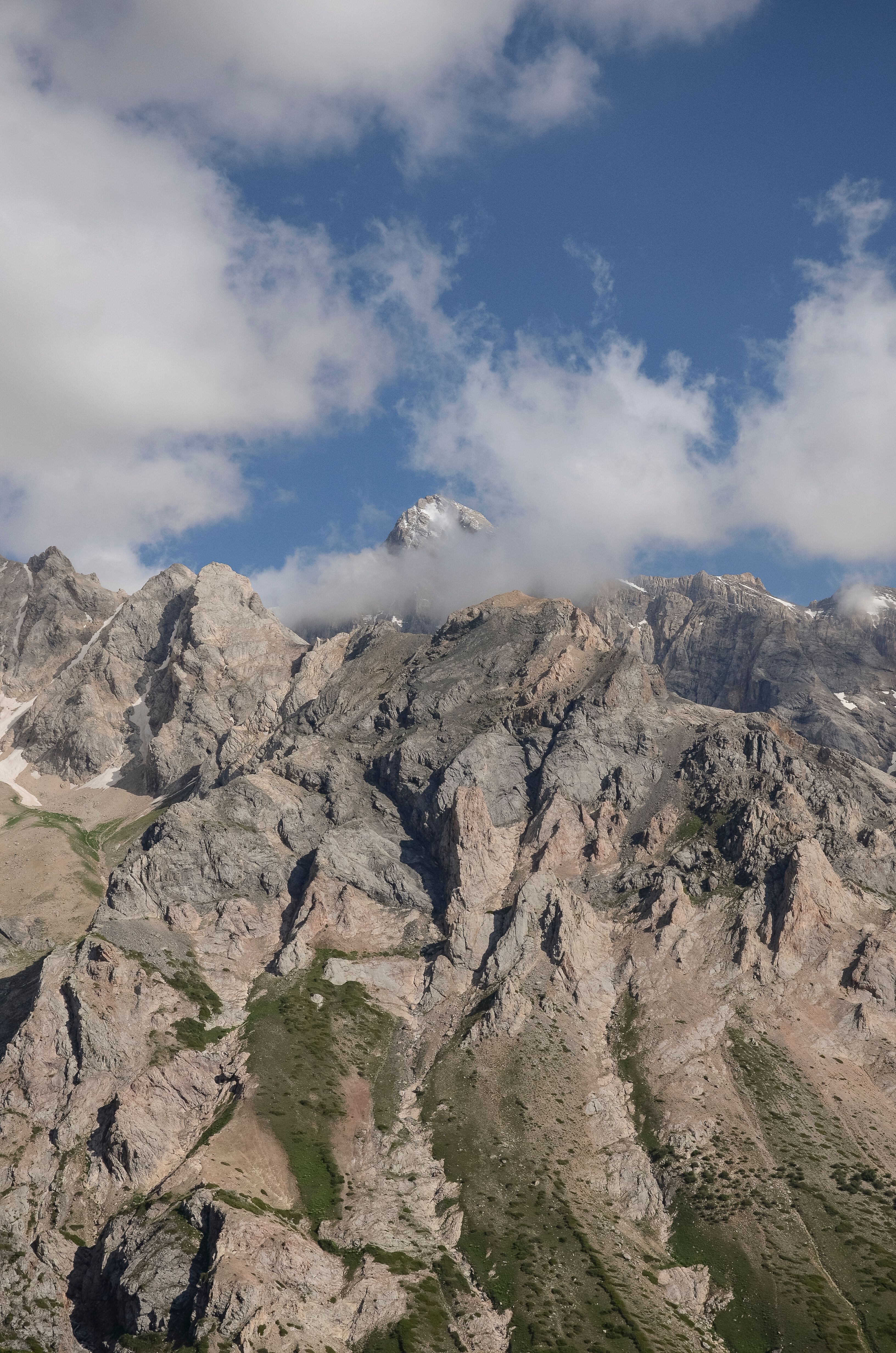 A mountain with clouds and a blue sky · Free Stock Photo