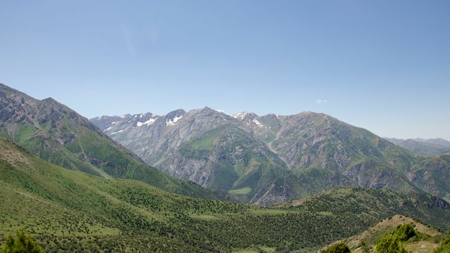 Stunning panoramic view of lush green mountains near Shymkent, Kazakhstan, under a clear blue sky. — lounges at Shymkent Airport