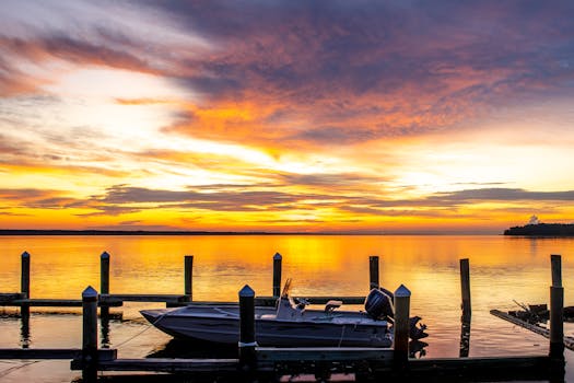 Tranquil sunset over Indian Pass Marina with boats and vibrant skies.