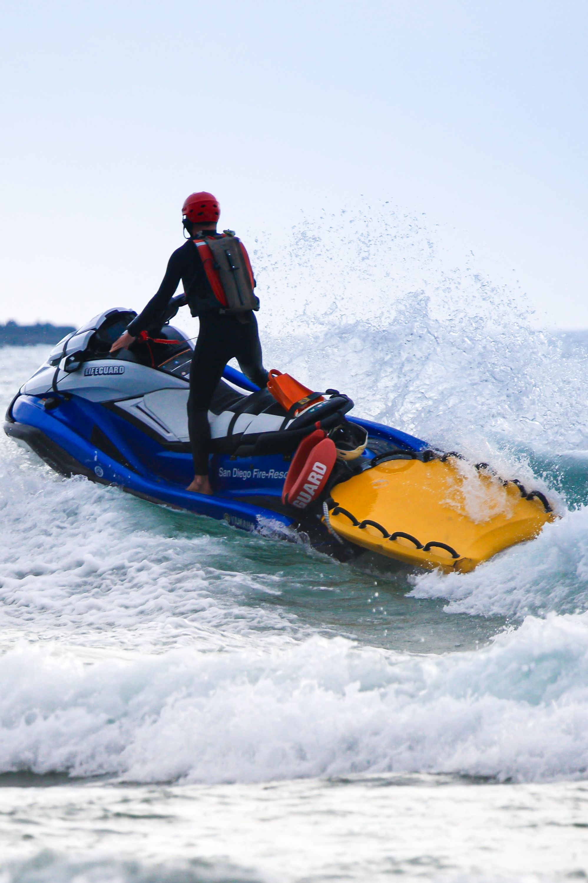 Rescue operation on jet ski in ocean, showcasing water sports excitement.