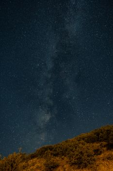 Captivating view of a starry night sky with the Milky Way above a hill.