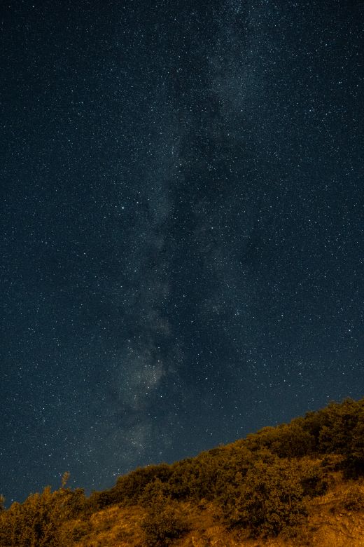 Star field above a moonlit ridge — photo by Zeynep Sude Emek on Pexels