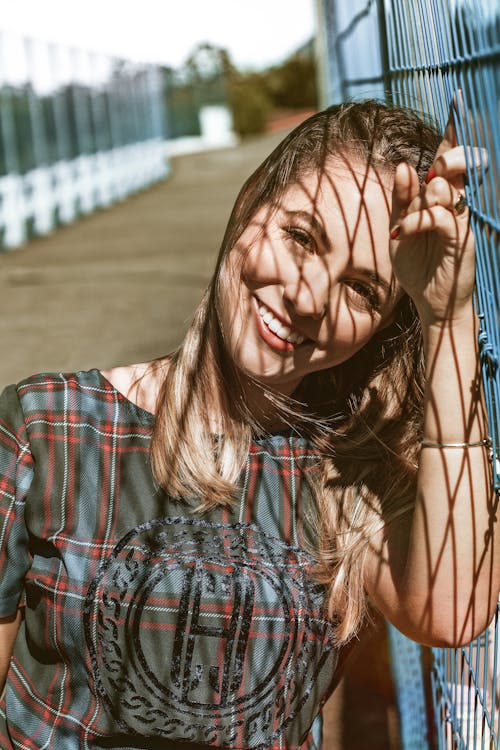 Photo Of Woman Leaning On Fence