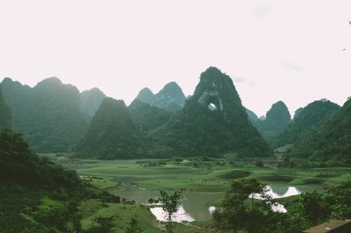 Free Lush green mountains and a serene lake in Cao Bang, Vietnam. Stock Photo
