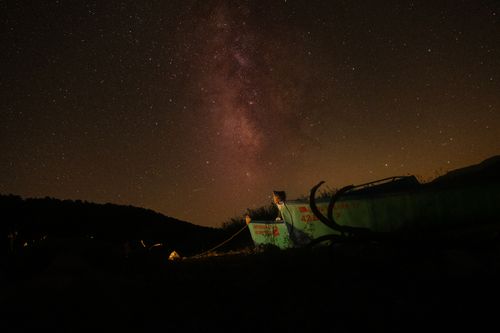 Free Captivating image of the Milky Way galaxy illuminating the night sky over a mountainous landscape. Stock Photo