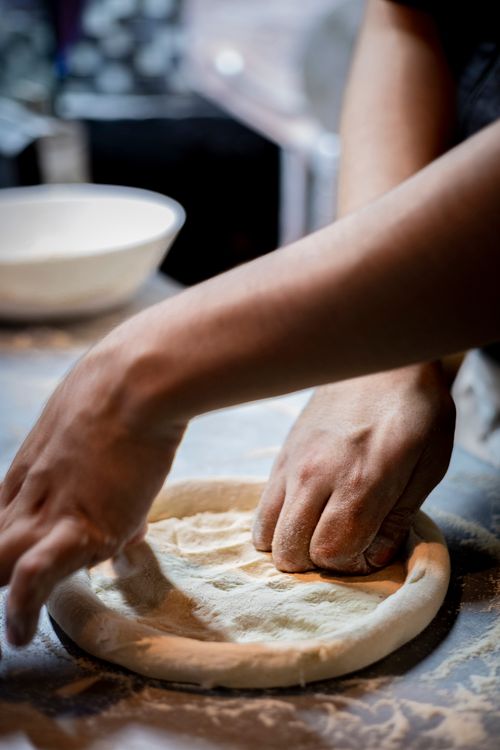 Free Close-up of hands kneading dough in a cozy kitchen. Perfect for baking themes. Stock Photo