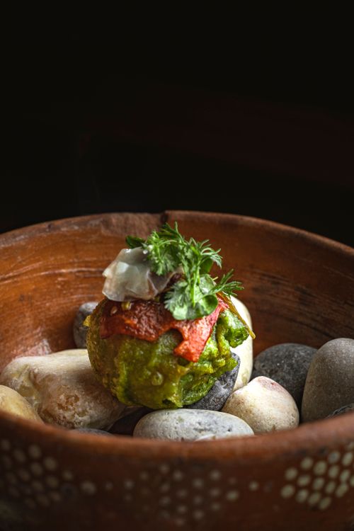 Free A rustic vegetable dish garnished with herbs in an artistic stone bowl setting. Stock Photo