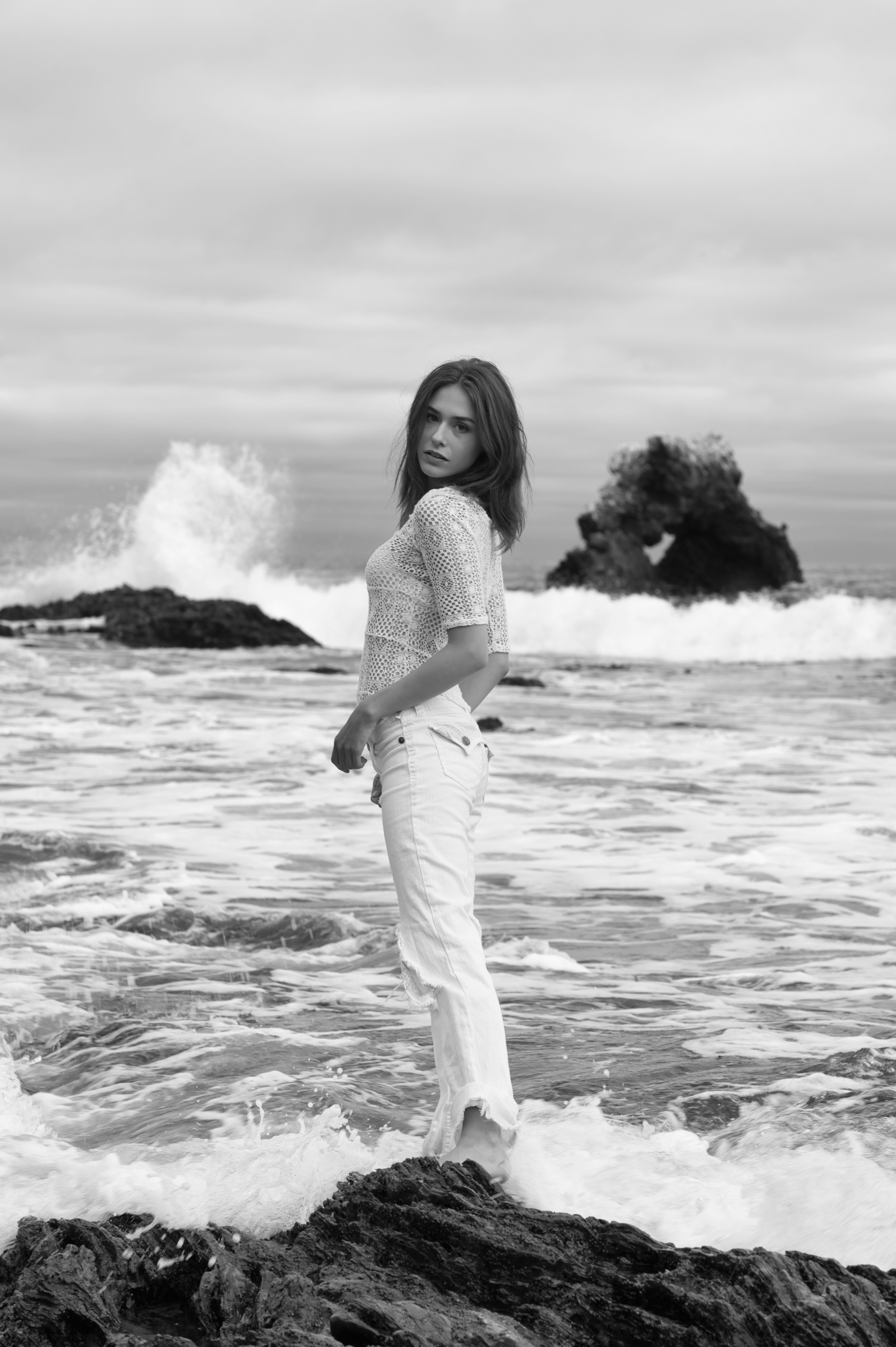 Black and White Photo of a Woman Standing on a Beach · Free Stock Photo