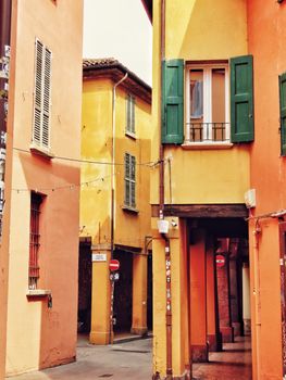 Vibrant narrow street with colorful buildings and classic Mediterranean architecture in the daytime.