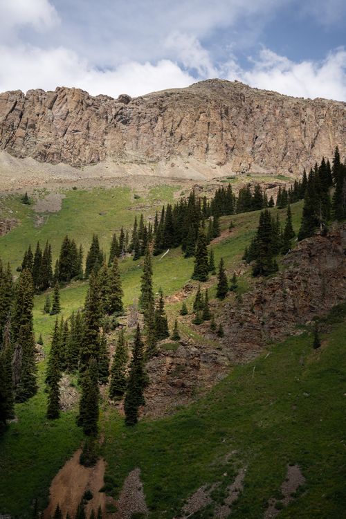 Free Lush green valleys and rugged mountain peaks under a bright sky. Stock Photo