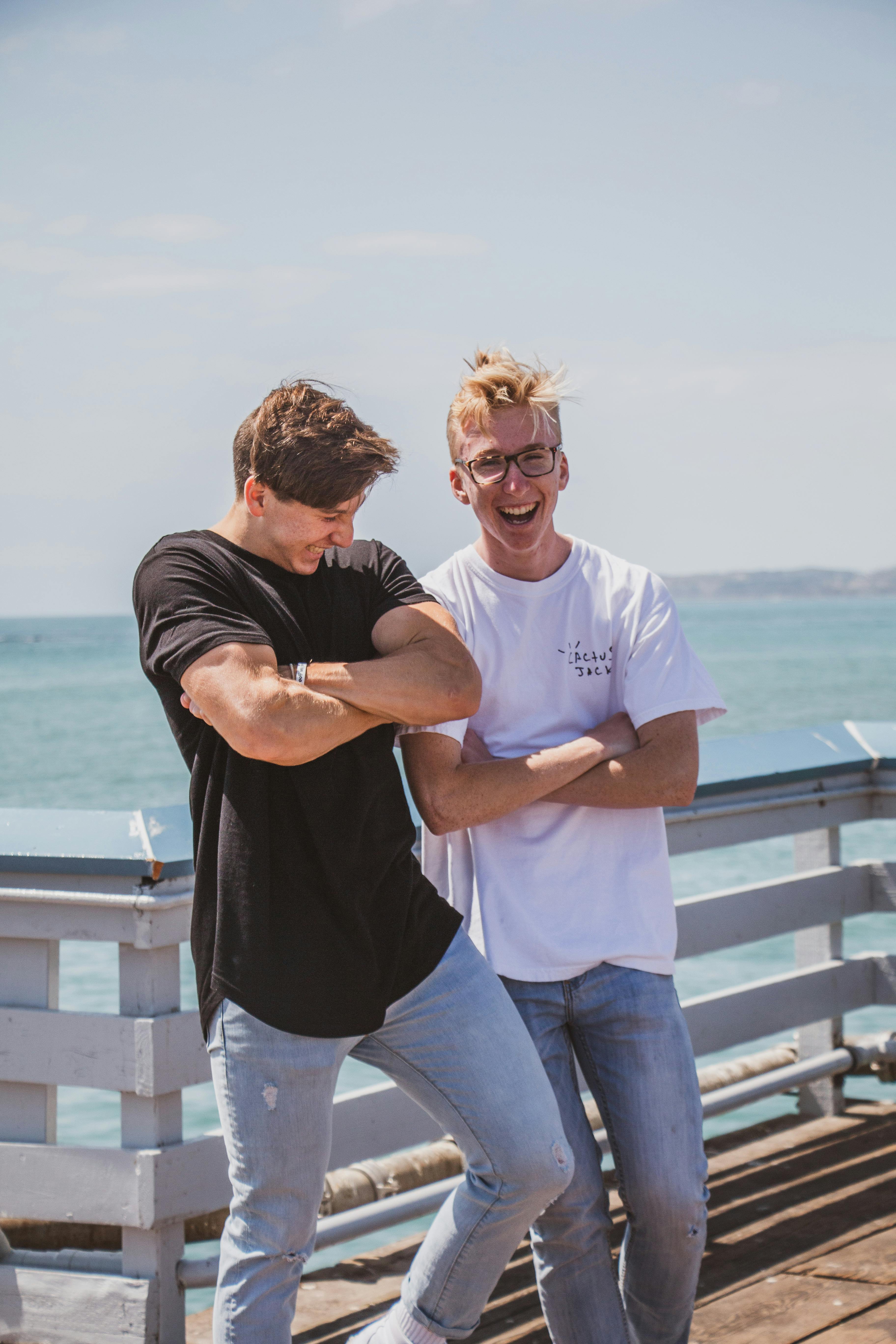 photo of men leaning on fence