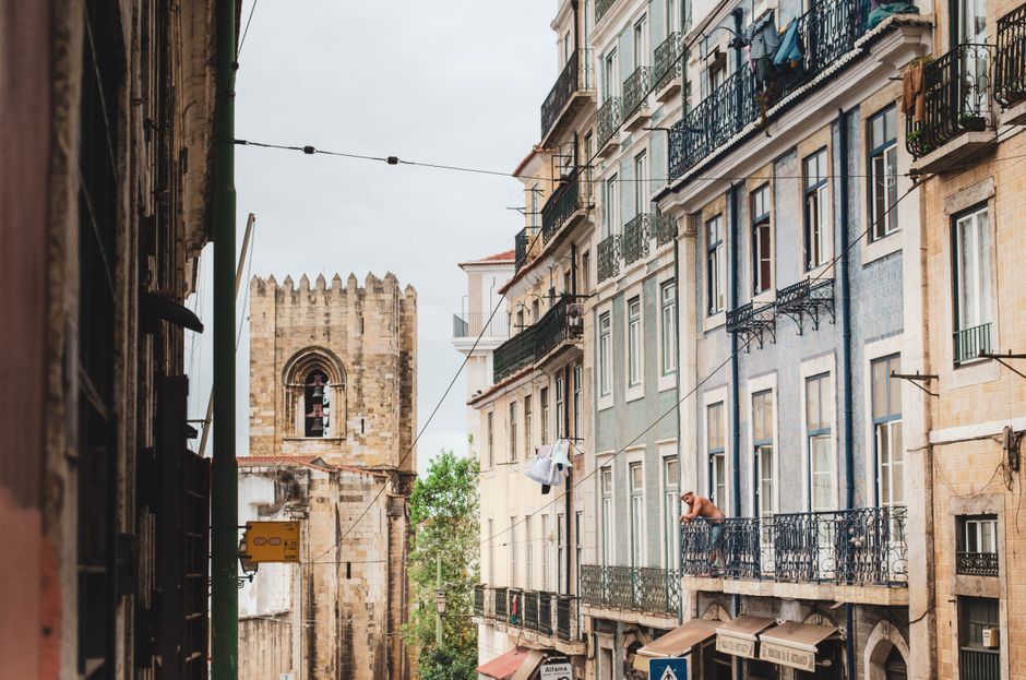 Cozy apartment balcony overlooking the rooftops of Alfama in Lisbon, Portugal.