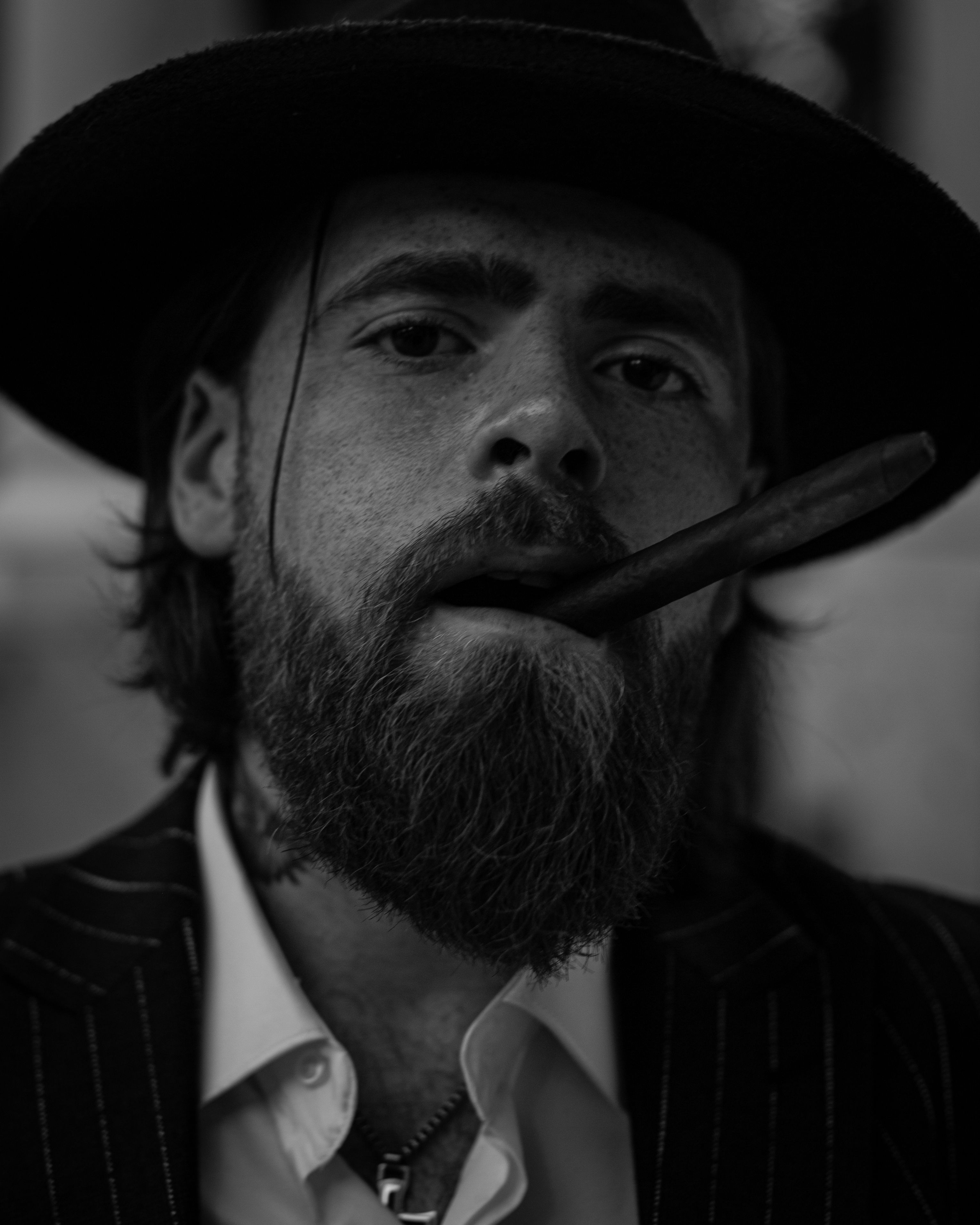A man with a beard and hat smoking a cigar · Free Stock Photo