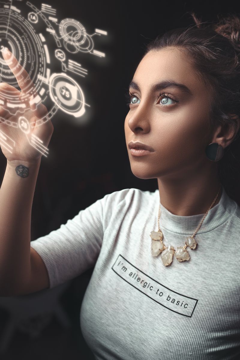 Woman in a modern setting interacting with a holographic user interface. Futuristic concept.