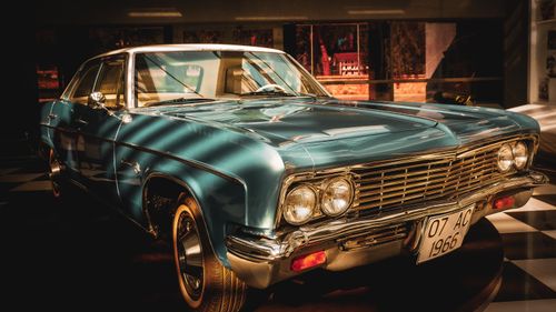 Free Classic vintage car displayed indoors showcasing elegant design and chrome detail. Stock Photo