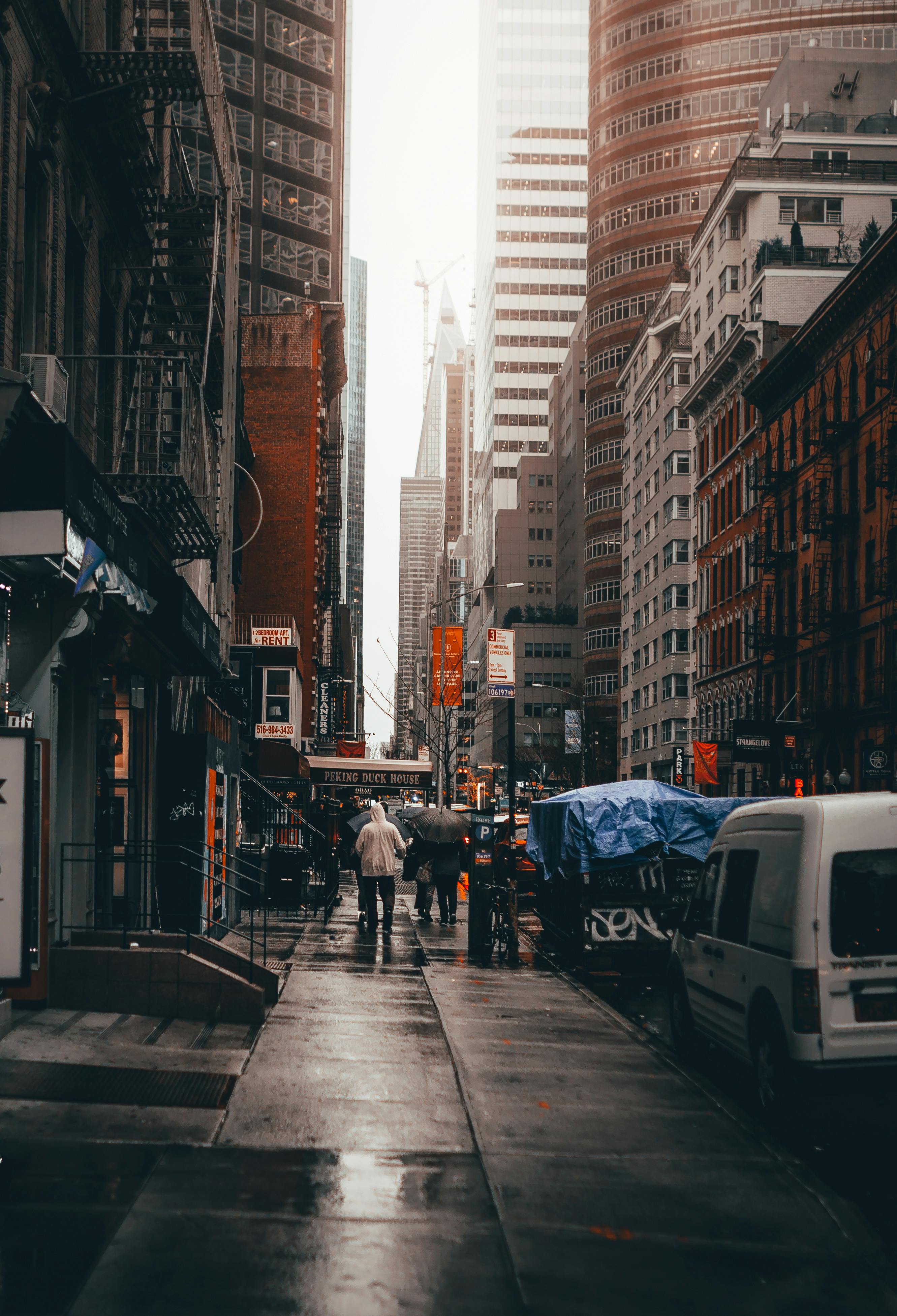 people walking on street between buildings