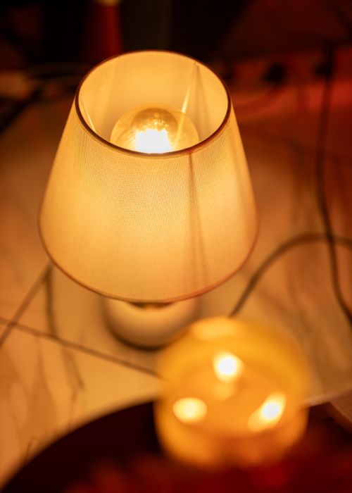 Free A warmly lit bedside lamp casting a cozy glow indoors in Accra, Ghana. Stock Photo