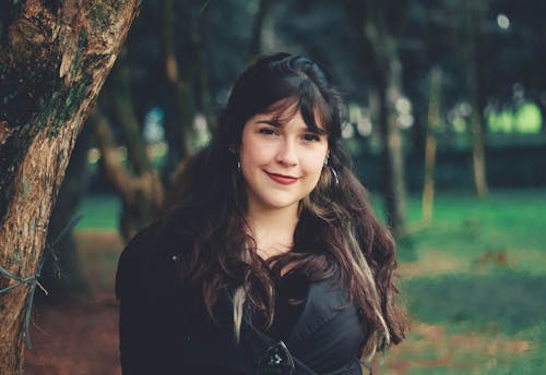 Woman Standing Beside Tree