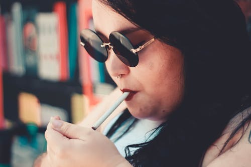 Close-Up Photo Of Woman Smoking Cigarette