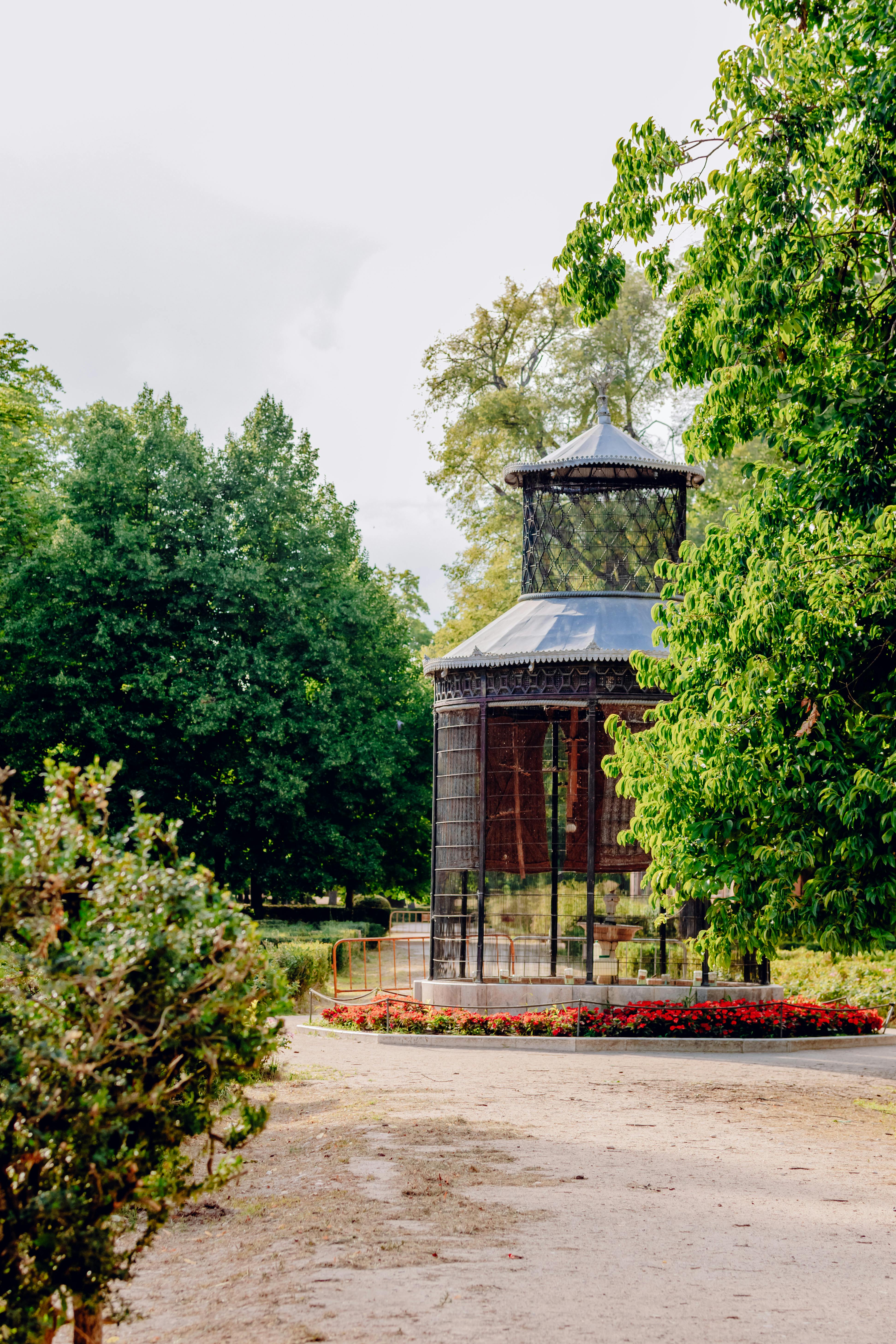 a gazebo in a park surrounded by trees