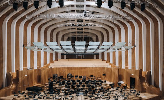 Spacious modern auditorium featuring wooden interior architecture and empty seating.