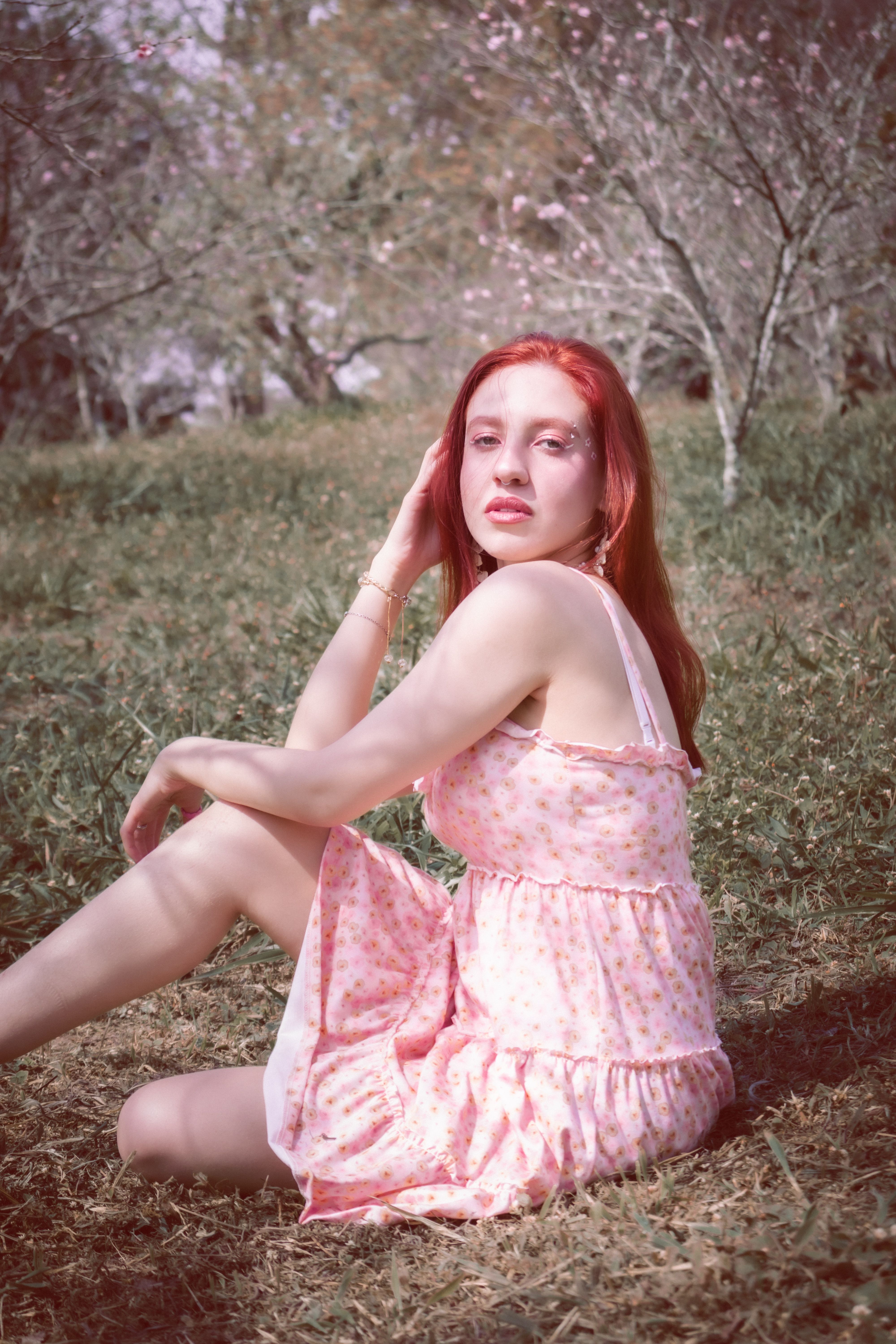 A woman with red hair sitting on the ground · Free Stock Photo