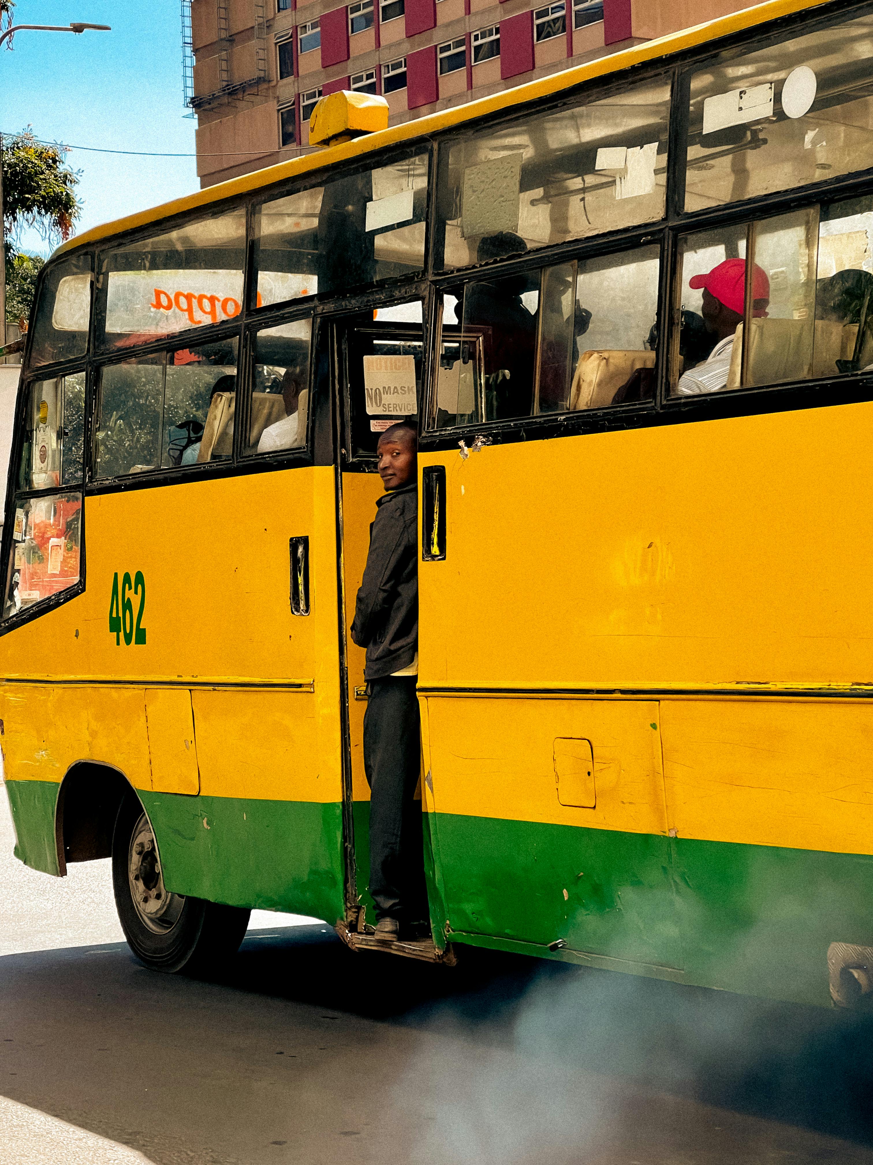 a yellow and green bus with smoke coming out of it