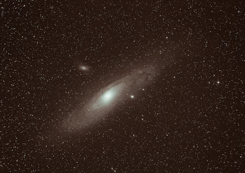 Dramatic image of the Andromeda Galaxy surrounded by countless stars in the night sky.