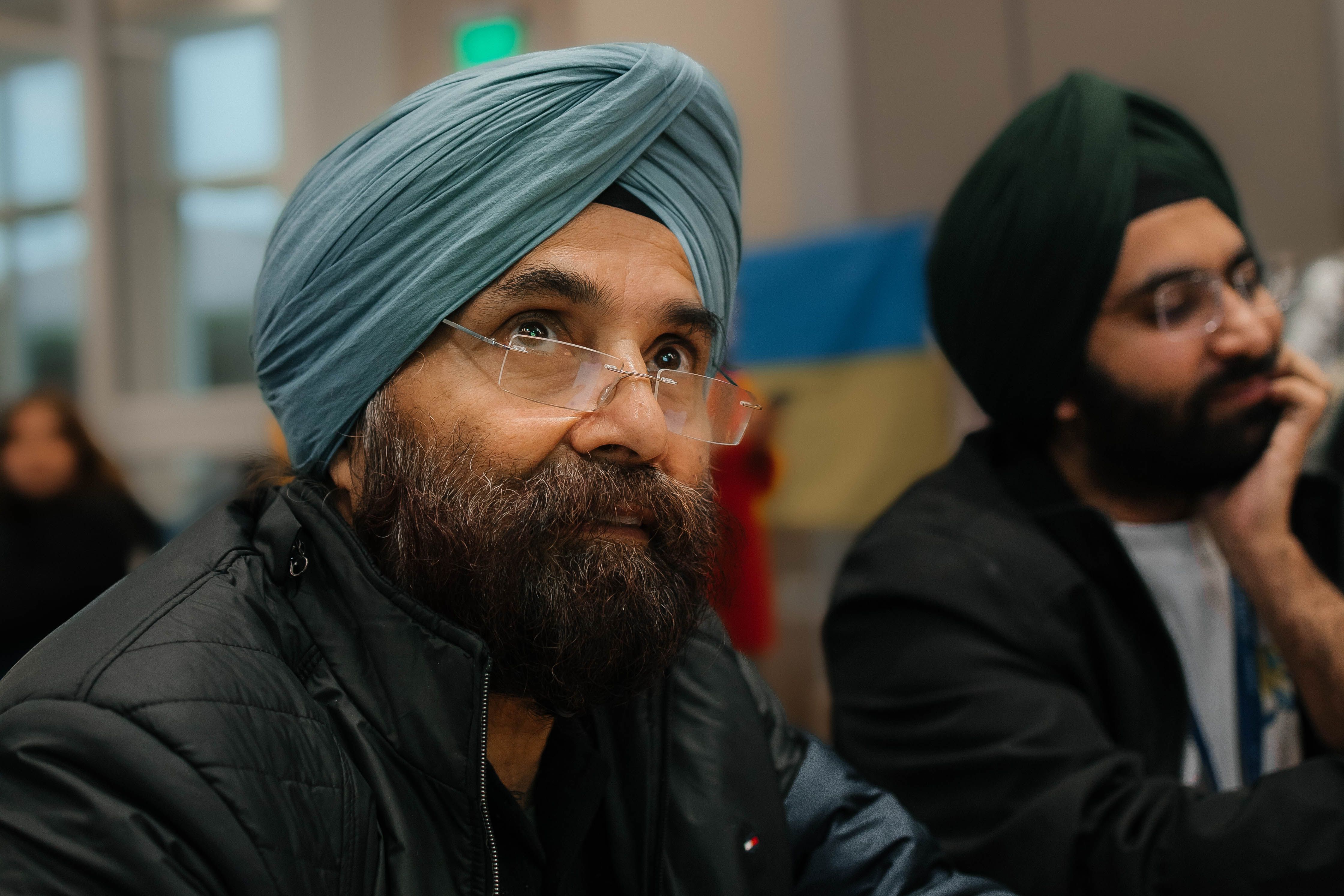 Close-up portrait of two adult men wearing turbans, indoors