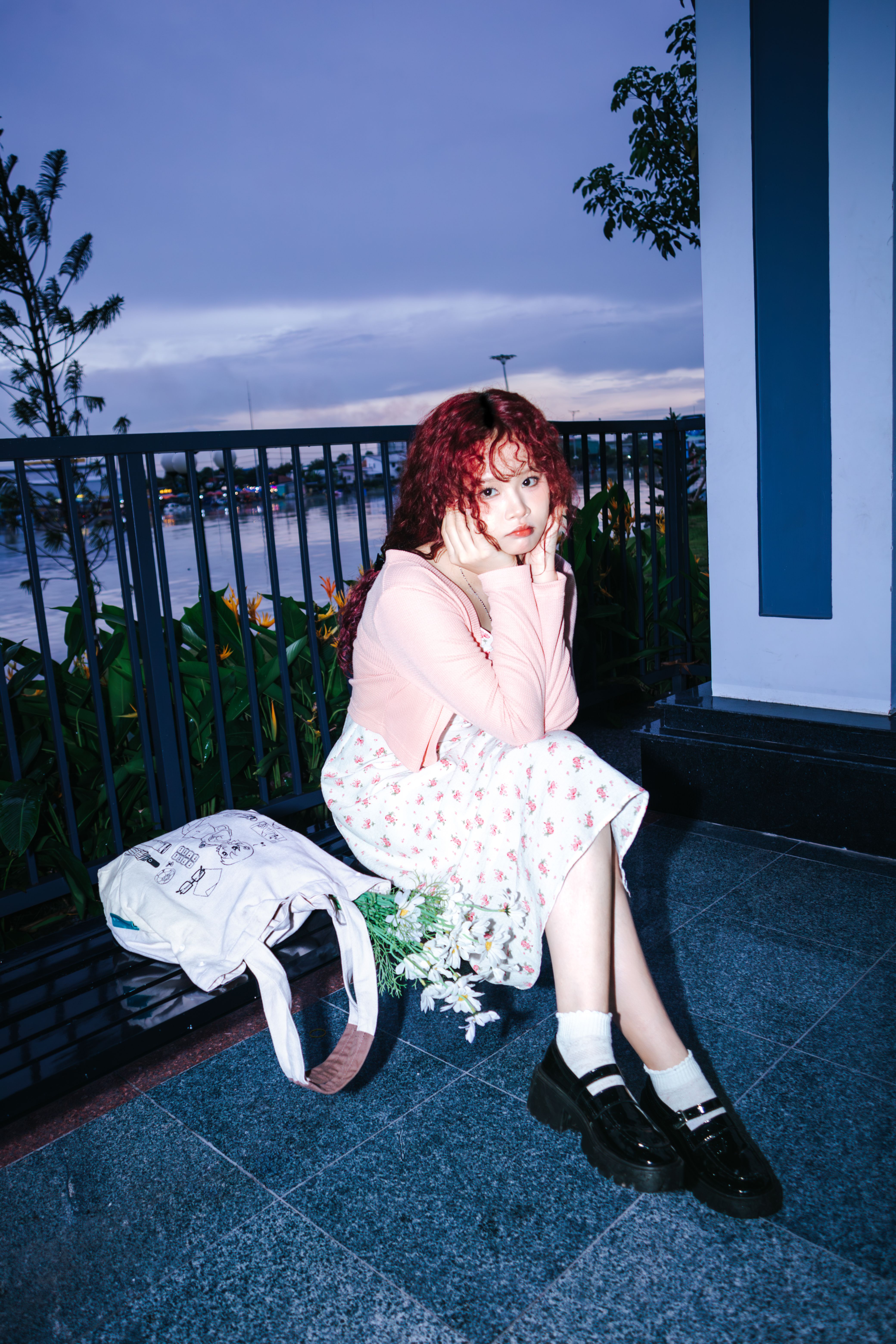 A girl with red hair sitting on a bench · Free Stock Photo