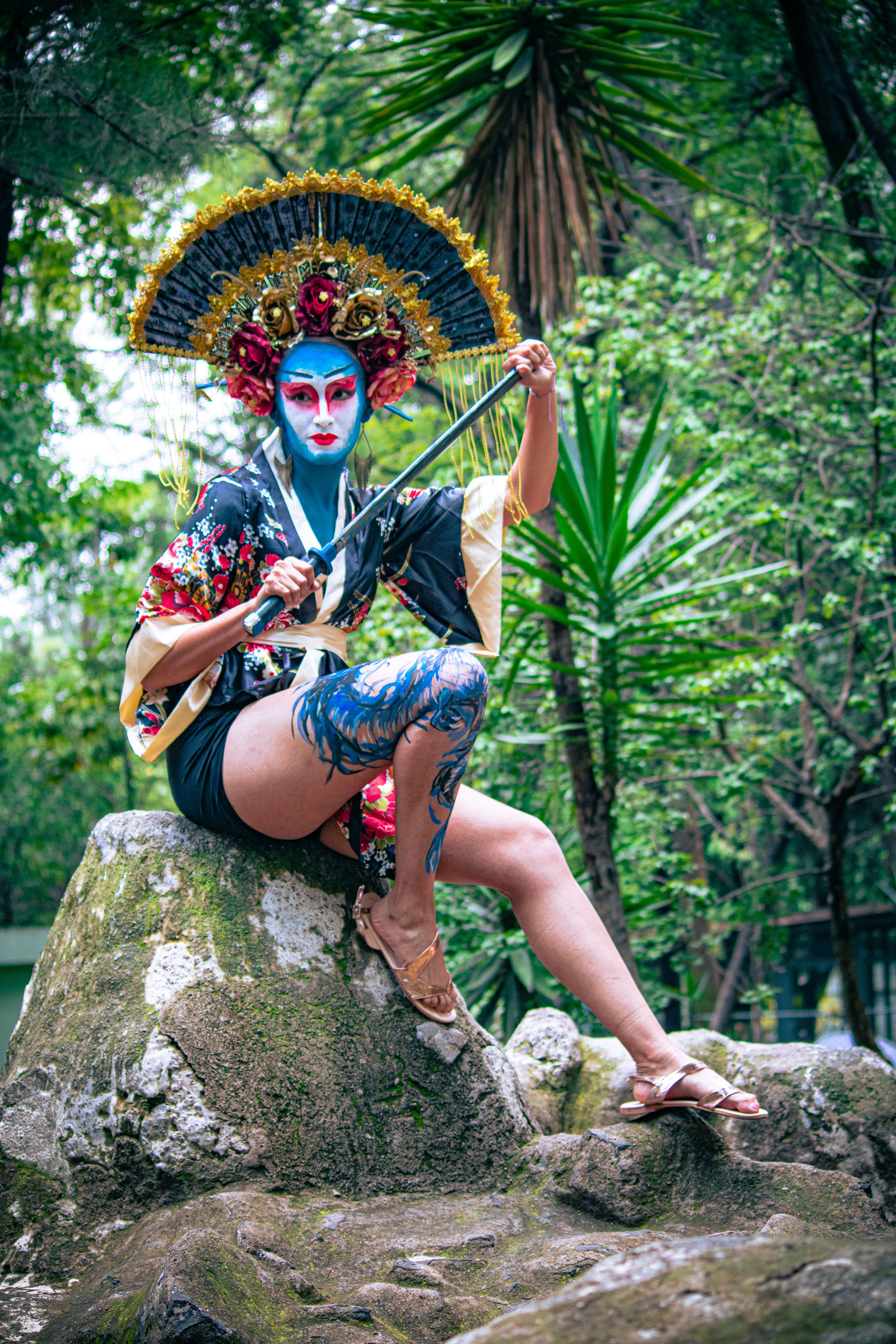 A woman in a costume sitting on a rock · Free Stock Photo