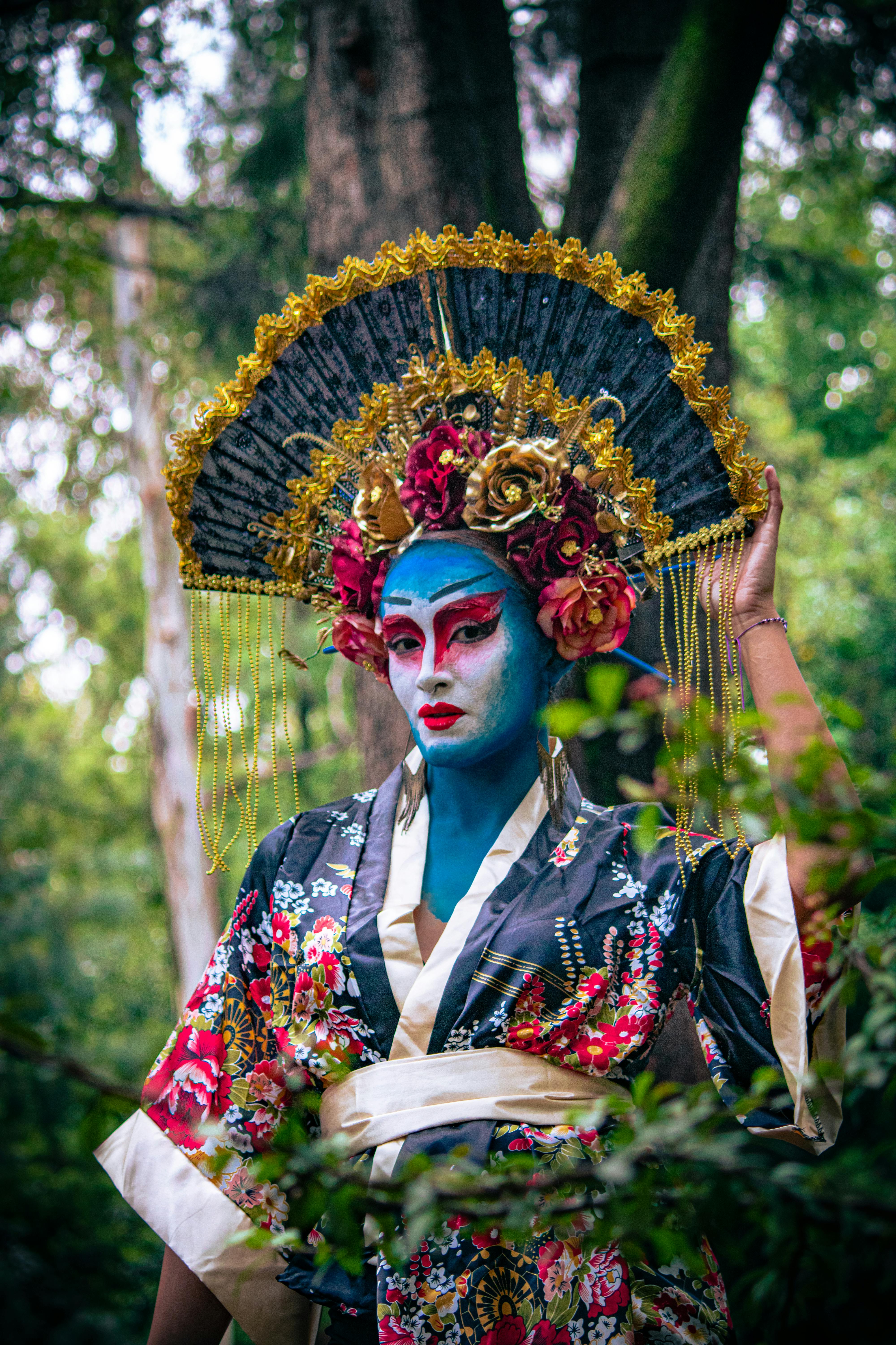 a woman in a blue and white costume with blue face paint