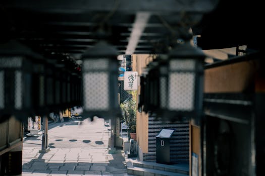 A serene view of a traditional alley in Osaka, adorned with hanging lanterns, showcasing urban architecture.