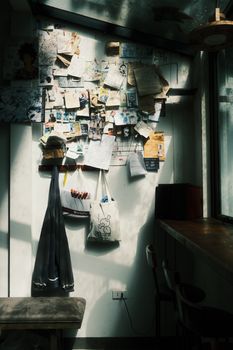A sunlit room interior with a creative bulletin board filled with notes and inspirations.