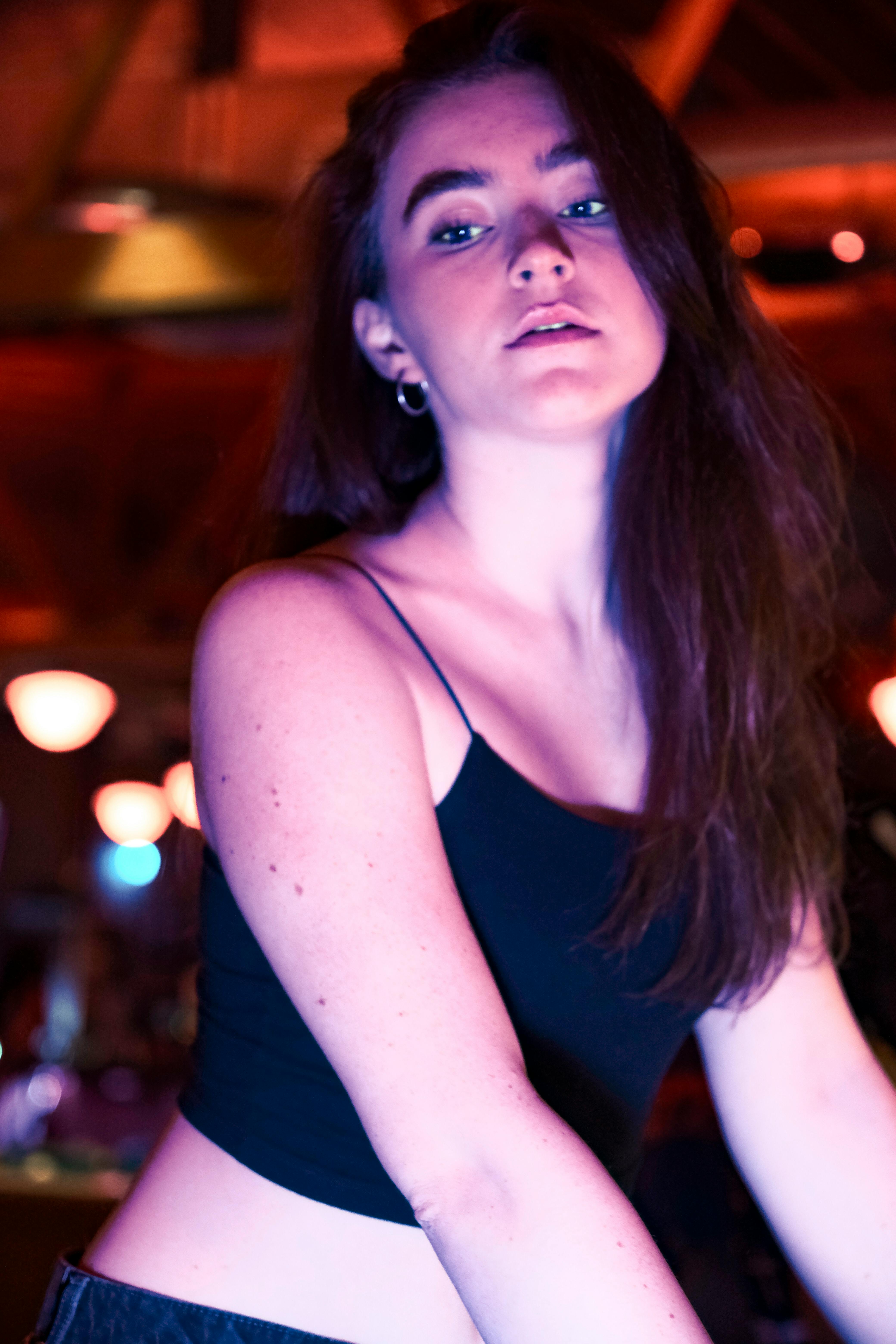 a young woman in a black top and skirt