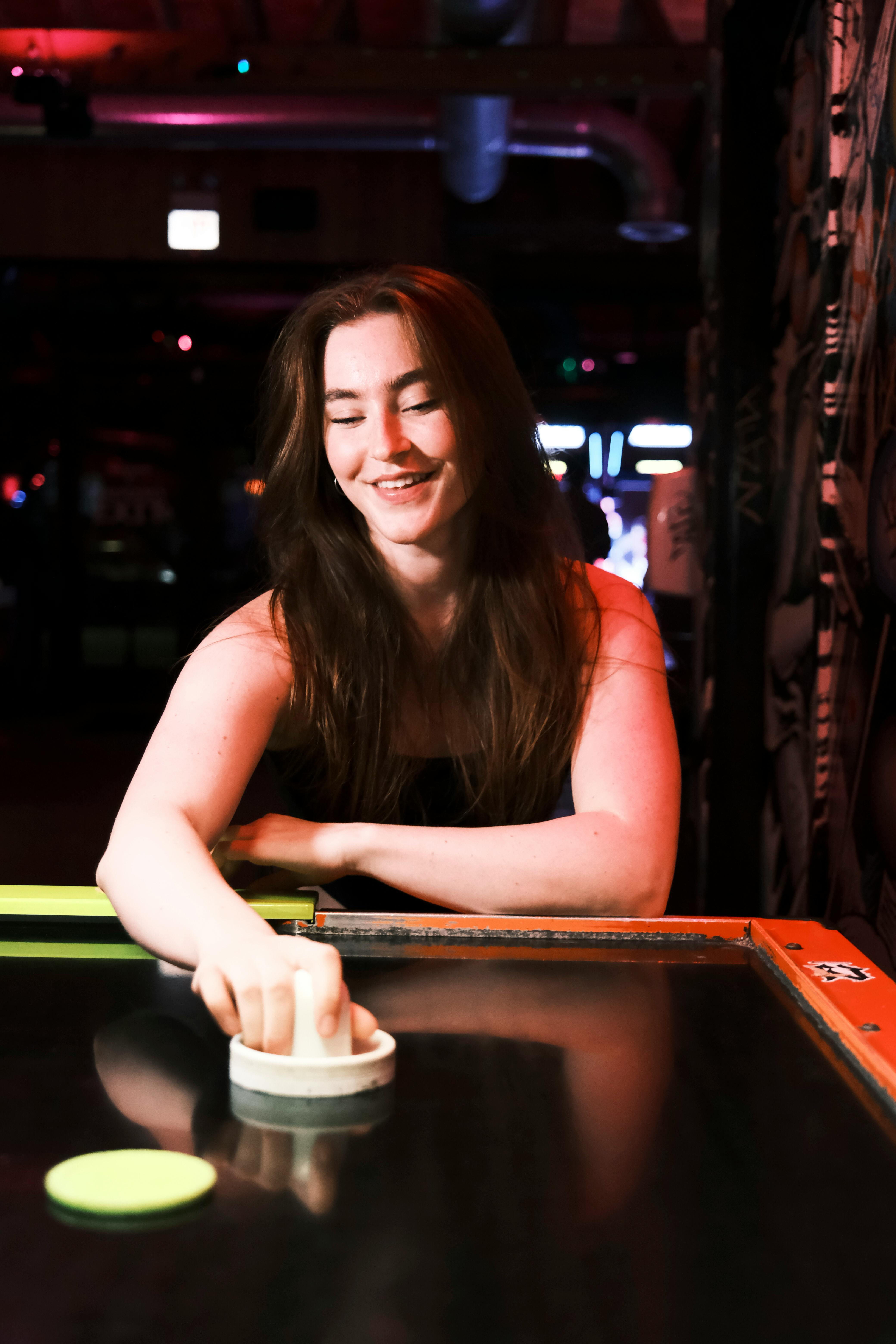 a woman is smiling while playing a game