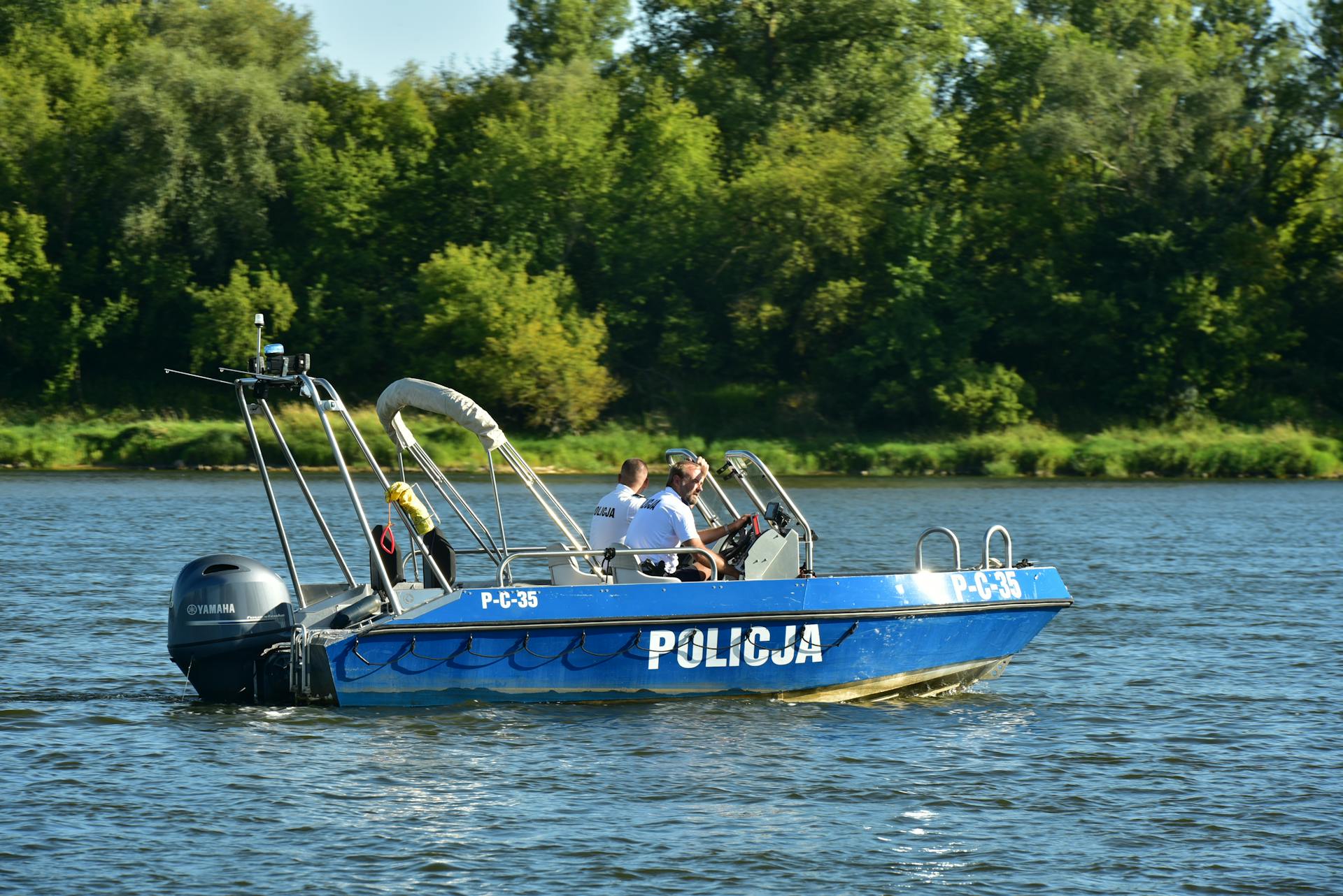 A police boat on the water with two people on it
