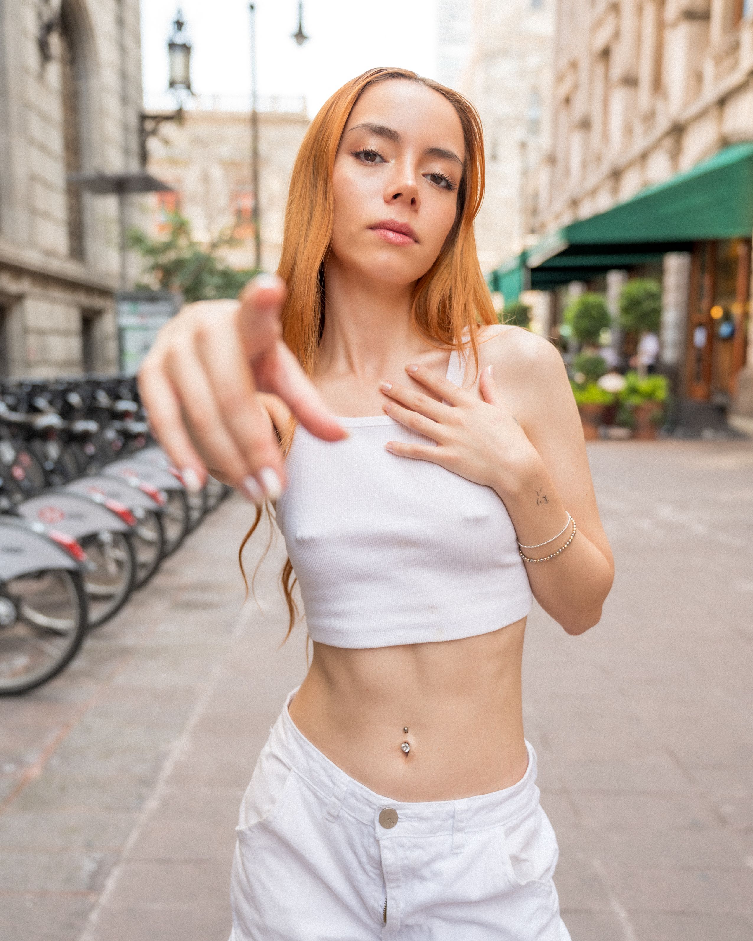 Stylish young woman posing confidently in a vibrant urban scene in Mexico City.