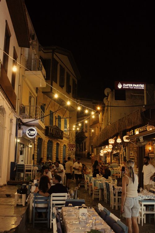 Free Bustling outdoor restaurant on a quaint cobblestone street at night. Stock Photo