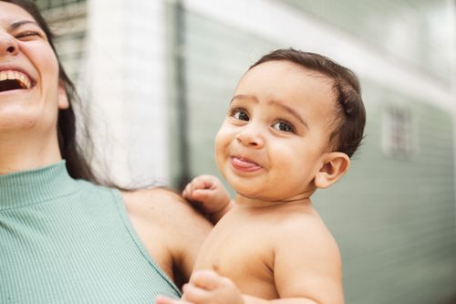 Free Heartwarming moment of a mother and baby sharing laughter indoors, capturing pure joy and affection. Stock Photo
