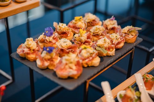 Free Delicious gourmet appetizers beautifully presented on a slate platter at a sophisticated event. Stock Photo