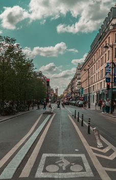 Dynamic street view of a bustling urban area with traffic and pedestrians.