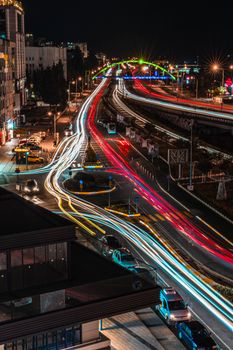 Dynamic light trails on a busy city expressway showcasing urban nightlife and movement.