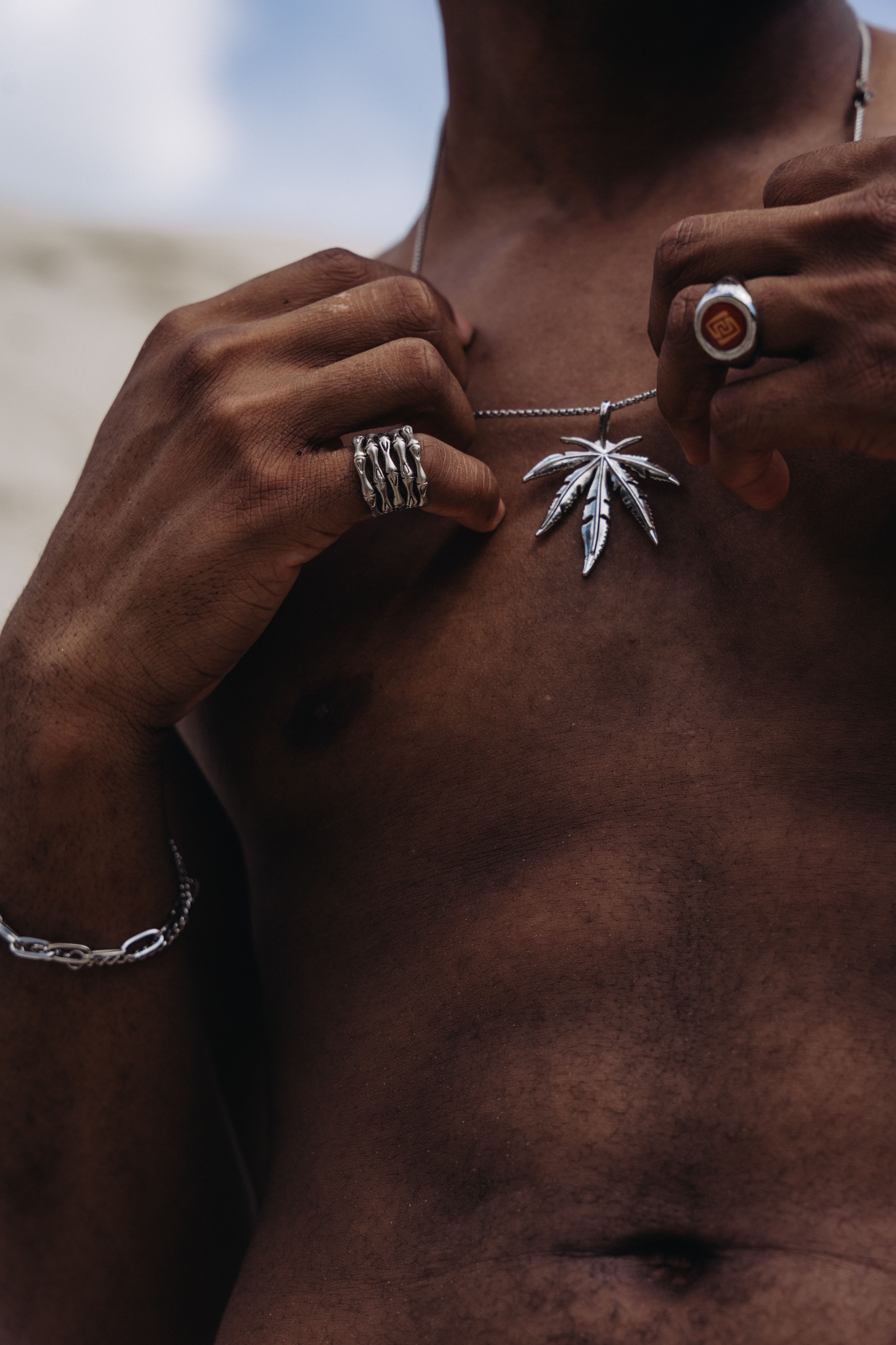 A man with a necklace and rings on his chest · Free Stock Photo